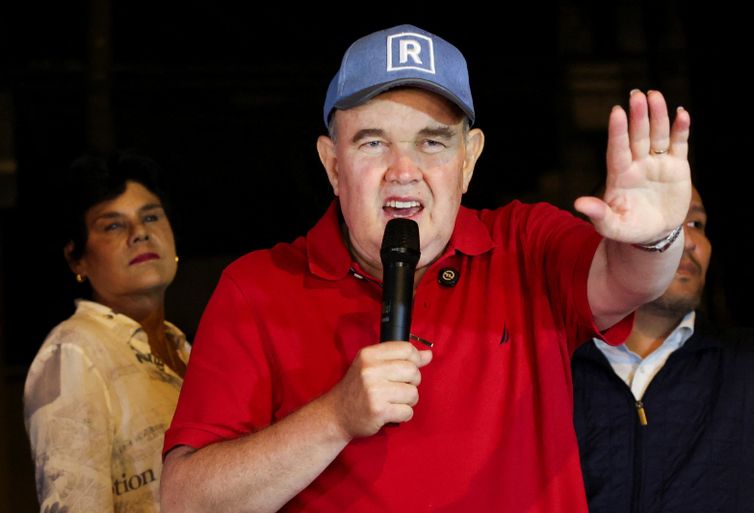 Peru's presidential candidate Rafael Lopez Aliaga speaks as people gather outside Peru's electoral headquarters amid concerns about the voting process during the country's general election, in Lima, Peru, April 14, 2026. REUTERS/Manuel Orbegozo